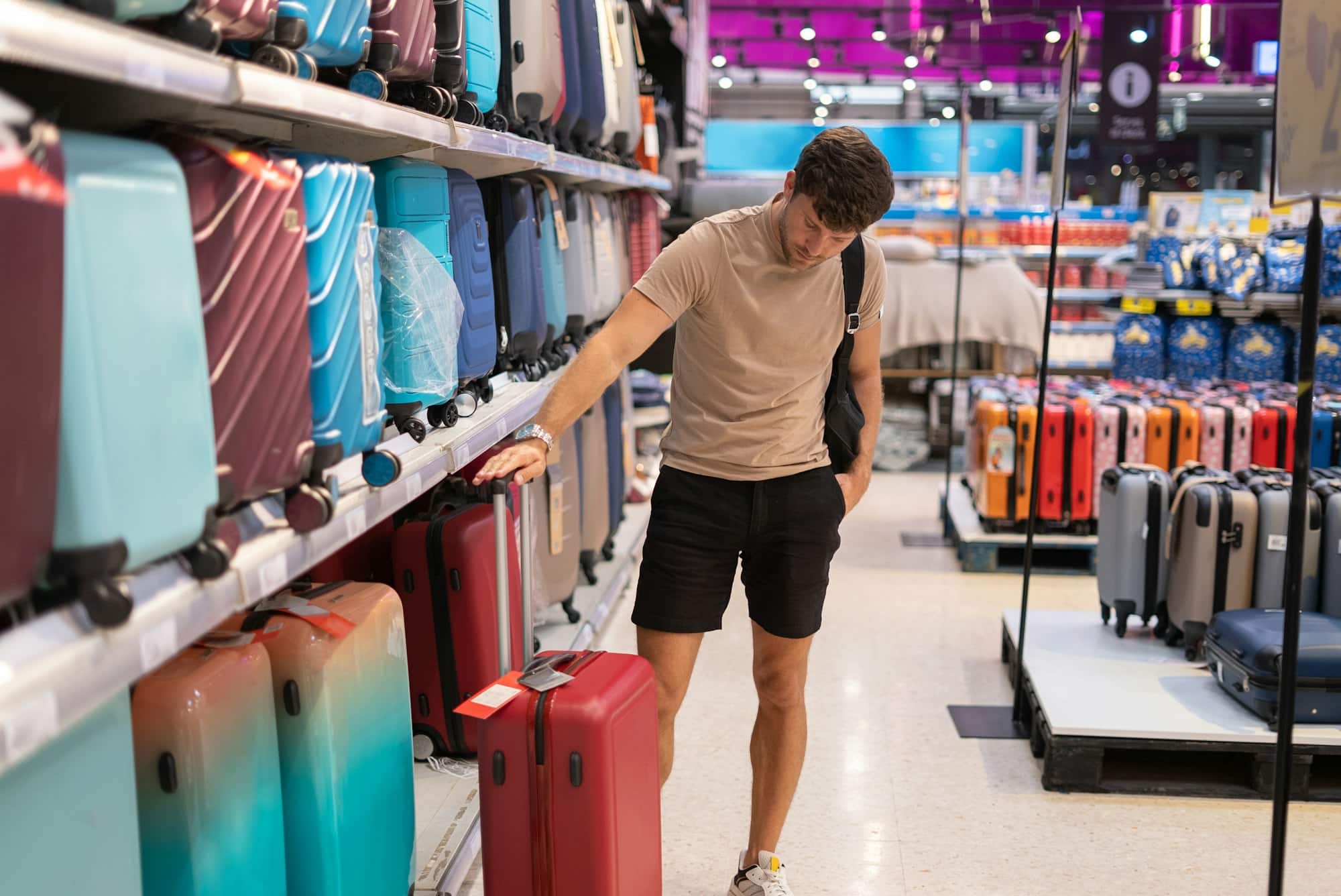 Male client checking suitcase in shop